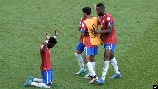 Costa Rica's Keysher Fuller, left, and teammates celebrate after their win in the World Cup, group E soccer match between Japan and Costa Rica, at the Ahmad Bin Ali Stadium in Al Rayyan, Qatar, Nov. 27, 2022.