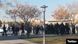 A screengrab from UGC video posted on Twitter Dec. 7, 2022, purports to show students clashing with security forces in Mashhad, Iran.