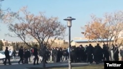 A screengrab from UGC video posted on Twitter Dec. 7, 2022, purports to show students clashing with security forces in Mashhad, Iran.