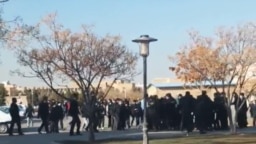 FILE - A screengrab from UGC video posted on Twitter Dec. 7, 2022, purports to show students clashing with security forces in Mashhad, Iran.