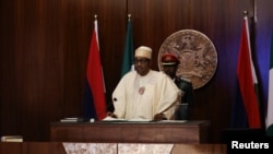 Nigerian President Muhammadu Buhari speaks during the launch of the new Nigerian currency in Abuja, Nov. 23, 2022. Buhari said, Nov. 30, 2022, the war between Russia and Ukraine is allowing arms and fighters to stream into the Lake Chad region.