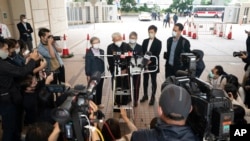 Cardinal Joseph Zen, second from left, speaks to members of the media at the West Kowloon Magistrates's Courts after the verdict session in Hong Kong, Friday, Nov. 25, 2022.