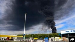 FILE - Smoke rises from an area controlled by Russian-backed separatist forces in Makiivka, 15 km east of Donetsk, eastern Ukraine, May 4, 2022. A HIMARS strike on the city Sunday leh at least 63 Russian soldiers left.