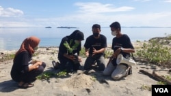 Anak-anak dalam Aksi Generasi Iklim melakukan penanaman pohon di pinggir pantai desa Balaesang Tanjung, Kabupaten Donggala, Sulawesi Tengah, Minggu (22 Mei 2022) (Foto : VOA/Yoanes Litha)