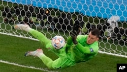 Croatia's goalkeeper Dominik Livakovic stops a penalty kick from Brazil's Rodrygo in a World Cup match in Al Rayyan, Qatar, Dec. 9, 2022.