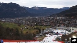 Competitors inspect the small strip of snow where they will compete in an alpine ski, men's World Cup slalom race, in Garmisch Partenkirchen, Germany, Jan. 4, 2023.