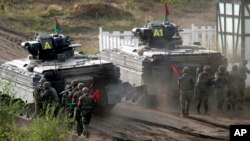 FILE - Soldiers follow a Marder infantry fighting vehicle during a media event by the German Bundeswehr in Bergen near Hannover, Germany, Sept. 28, 2011. The U.S. and Germany are sending Ukraine an array of armored vehicles to expand its ability to move troops and beef up its forces against Russia.