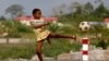 A boy plays soccer at the village of Bikuy on the outskirts of Bata, Equatorial Guinea, February 3, 2015. 