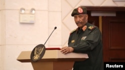 FILE - Sudan's military leader General Abdel Fattah al-Burhan stands at the podium during a ceremony to sign a framework agreement between military rulers and civilian powers in Khartoum, Sudan, Dec. 5, 2022.