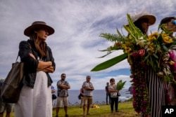 French-born artist Delphine Poulain attends the burial ceremony of a friend, at the cemetery in Hanga Roa, Rapa Nui, or Easter Island, Chile, Saturday, Nov. 26, 2022. (AP Photo/Esteban Felix)