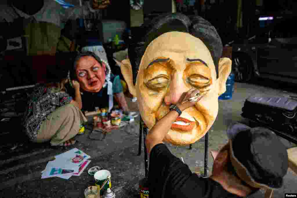 Filipino activists paint effigies depicting Philippine President Ferdinand Marcos Jr. and Philippine Vice President Sara Vicenta Zimmerman Duterte-Carpio, ahead of Human Rights Day, in Quezon City, Metro Manila, Philippines.