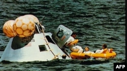 A NASA picture taken on Oct. 22, 1968 shows the recovery in the Gulf of Mexico of the Apollo 7 command module with US astronauts Walter Schirra, Donn Eisele, Walter Cunningham after an eleven-day Earth-orbital mission which was the first manned mission in the Apollo program.