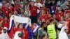 A security officer is seen among Serbian fans during the World Cup Group G Serbia against Switzerland match at Stadium 974 in Doha, Qatar, Dec. 2, 2022.