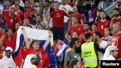 A security officer is seen among Serbian fans during the World Cup Group G Serbia against Switzerland match at Stadium 974 in Doha, Qatar, Dec. 2, 2022.