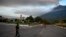 A traffic safety officer stands next to a closed-off road after the Fuego volcano erupted, in Alotenango, some 65 kilometers southwest of Guatemala City, Guatemala, Dec. 11, 2022.