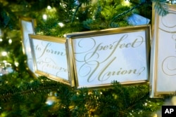 Framed segments of the Preamble to the U.S. Constitution decorate a tree in the Grand Foyer of the White House during a press preview of holiday decorations at the White House, Monday, Nov. 28, 2022, in Washington. (AP Photo/Patrick Semansky)