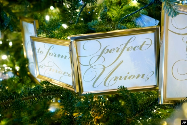 Framed segments of the Preamble to the U.S. Constitution decorate a tree in the Grand Foyer of the White House during a press preview of holiday decorations at the White House, Monday, Nov. 28, 2022, in Washington. (AP Photo/Patrick Semansky)