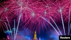 Fireworks explode over Wat Arun during New Year celebrations in Bangkok on January 1, 2023. (Athit Perawongmetha/Reuters) 