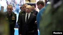 Russian President Vladimir Putin, Defense Minister Sergei Shoigu and Chief of the General Staff of Russian Armed Forces Valery Gerasimov attend an exhibition of military equipment after a meeting of the Defence Ministry Board in Moscow, Dec. 21, 2022. 