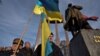 Activists and supporters of Ukrainian nationalist movements attend a rally to mark the 114th birth anniversary of Stepan Bandera, one of the founders of the Organisation of Ukrainian Nationalists (OUN), next to his monument in Lviv, Ukraine, Jan. 1, 2023. 