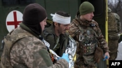 Ukrainian Army medics evacuate a wounded soldier not far from Soledar, Donetsk region, Jan. 14, 2023.