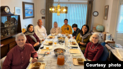 The Pennsylvania family of Judith Samkoff, front right, invited an Afghan refugee family to join them for their first Thanksgiving in the United States. One guest did not want to be identified in the photo. (Photo courtesy of the Jewish Federations of North America)