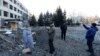 People look at the site of a missile strike that occurred during the night, as Russia's attacks on Ukraine continue, in Kramatorsk, Ukraine, Jan. 8, 2023. 