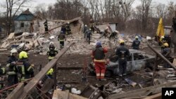 Emergency workers remove debris of a house destroyed following a Russian missile strike in Kyiv, Ukraine, Thursday, Dec. 29, 2022. (AP Photo/Roman Hrytsyna)