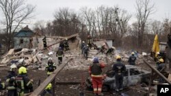 Emergency workers remove debris of a house destroyed following a Russian missile strike in Kyiv, Ukraine, Thursday, Dec. 29, 2022. (AP Photo/Roman Hrytsyna)