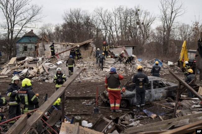 FILE - Emergency workers remove debris of a house destroyed following a Russian missile strike in Kyiv, Ukraine, Thursday, Dec. 29, 2022. (AP Photo/Roman Hrytsyna)