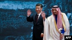 FILE - China's President Xi Jinping (L) and Saudi King Salman bin Abdulaziz (R) attend the "Road to the Arab Republic" at China National Museum in Beijing, March 16, 2017. Xi will arrive in Saudi Arabia on Dec. 7, 2022, for a three-day visit.