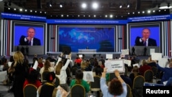 Russian President Vladimir Putin gestures as he holds his annual end-of-year news conference in Moscow, Dec. 23, 2021.