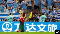 Portugal's Bruno Fernandes celebrates his side's second goal on a penalty during the World Cup group H soccer match between Portugal and Uruguay, at the Lusail Stadium in Lusail, Qatar, Nov. 28, 2022. 