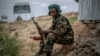 FILE - A fighter loyal to the Tigray People's Liberation Front (TPLF) mans a guard post on the outskirts of the town of Hawzen, then-controlled by the group but later re-taken by government forces, in the Tigray region of northern Ethiopia on May 7, 2021.