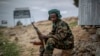 FILE - A fighter loyal to the Tigray People's Liberation Front (TPLF) mans a guard post on the outskirts of the town of Hawzen, then-controlled by the group but later re-taken by government forces, in the Tigray region of northern Ethiopia on May 7, 2021.
