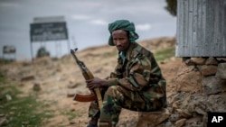 FILE - A fighter loyal to the Tigray People's Liberation Front (TPLF) mans a guard post on the outskirts of the town of Hawzen, then-controlled by the group but later re-taken by government forces, in the Tigray region of northern Ethiopia on May 7, 2021.