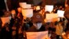 FILE - Protesters hold up blank papers and chant slogans as they march in protest in Beijing, Nov. 27, 2022. In a society where everything is closely monitored and censored, the white paper is a silent protest against users not being allowed to speak. 