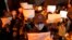 FILE - Protesters hold up blank papers and chant slogans as they march in protest in Beijing, Nov. 27, 2022. In a society where everything is closely monitored and censored, the white paper is a silent protest against users not being allowed to speak. 