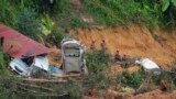 FILE - Rescue teams search for victims caught in a landslide in Batang Kali, Malaysia, Dec. 17, 2022.