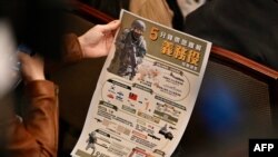 Poster yang menunjukkan rencana pemerintah Taiwan untuk memperpanjang wajib militer dalam konferensi pers di kantor kepresidenan di Taipei pada 27 Desember 2022. (Sam Yeh / AFP)