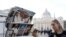 People look postcards showing Pope Francis and Pope Emeritus Benedict XVI in Rome, near the Vatican, Dec. 28, 2022. 