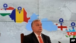 Hungarian Prime Minister Viktor Orban is backdropped by a screen showing the countries that signed a strategic energy partnership at the Cotroceni presidential palace in Bucharest, Romania, Dec. 17, 2022. 