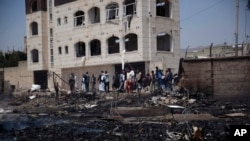 FILE - Yemenis inspect results of Saudi-led airstrikes on two houses in Sanaa, March 26, 2022. Violence in the Yemeni civil war paused in April 2022 under a U.N.-negotiated cease-fire that has largely held even though it expired in October. 
