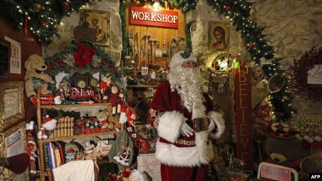 Despite its location in Jerusalem, the home of Palestinian Issa Kassissieh, dressed as Santa Claus, looks like it could be Santa's North Pole workshop on Nov. 30, 2022.