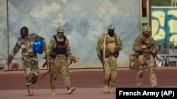 FILE: Three Russian mercenaries, right, are shown on patrol in northern Mali. Russia analysts say the Wagner Group of mercenaries is key to Putin's ambitions to re-impose Russian influence on Africa, and wider, a global scale. Taken January, 2022.