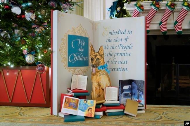 A depiction of President Joe Biden's dog Commander is on display in the State Dining Room of the White House during a press preview of holiday decorations at the White House, Monday, Nov. 28, 2022, in Washington. (AP Photo/Patrick Semansky)