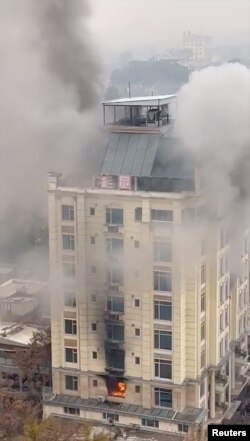 View of a hotel fire in Shahr-e-Naw neighborhood where gunfire was also heard in Kabul, Afghanistan December 12, 2022 in this still image from social media video obtained by REUTERS