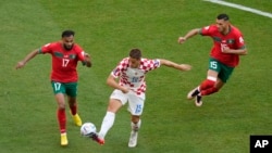 From left, Morocco's Sofiane Boufal, Croatia's Mario Pasalic, and Morocco's Selim Amallah vie for the ball during the World Cup group F soccer match between Morocco and Croatia at the Al Bayt Stadium in Al Khor, Qatar, Nov. 23, 2022.