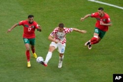 From left, Morocco's Sofiane Boufal, Croatia's Mario Pasalic, and Morocco's Selim Amallah vie for the ball during the World Cup group F soccer match between Morocco and Croatia at the Al Bayt Stadium in Al Khor, Qatar, Nov. 23, 2022.