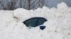 A car sits buried under snow after a winter storm rolled through Western New York, Dec. 28, 2022, in Buffalo N.Y.